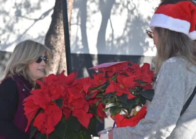 Elderhelp - Sally giving volunteers poinsettias